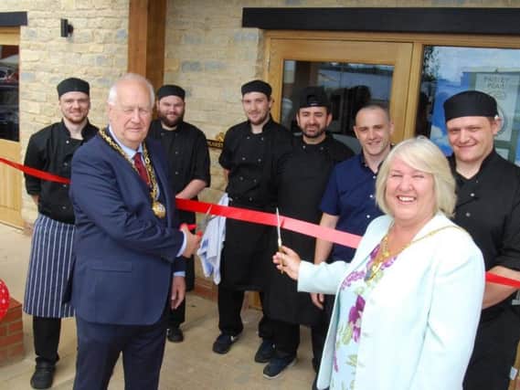 Cllr Rosie Herring (right) cuts the ribbon to celebrate the opening of The Paisley Pear, Brackley