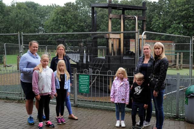 Staff, children and Friends of Hook Norton School members by the fire-damaged play equipment. NNL-190730-141647009