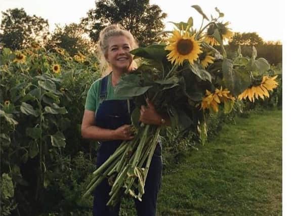 Emma Wright, from Lodge Farm, who raised ?5,334 for local charities by selling pick-your-own sunflowers NNL-190110-110446001