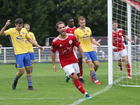 Brackley Town's Ellis Myles turns away in celebration after scoring the second goal against Warrington Town. Photo: Steve Prouse