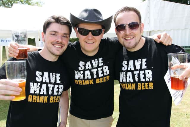 Brackley Beer Festival. Pictured, James Hart, Ben Gurney and Andrew Jones think of the environment as they sample some of the 60 beers on offer.