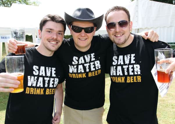 Brackley Beer Festival. Pictured, James Hart, Ben Gurney and Andrew Jones think of the environment as they sample some of the 60 beers on offer.