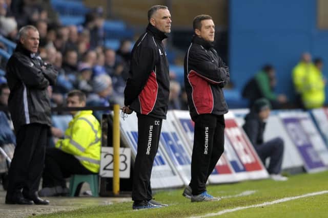 Jon Brady (right) and his assistant, Darren Collins, watch on at Gillingham in the first round