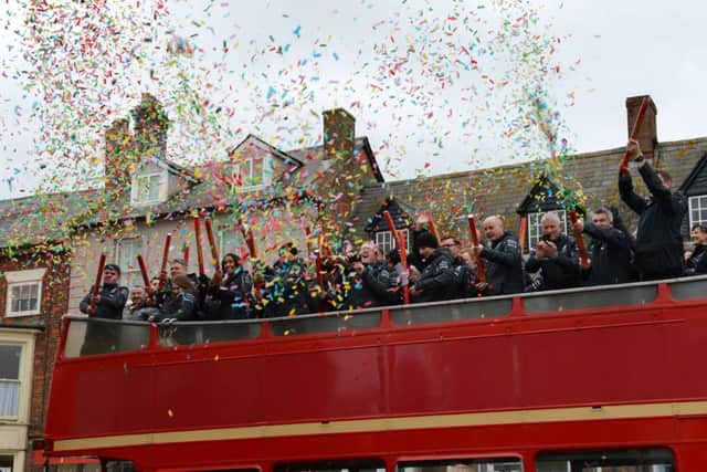 Mercedes F1 team parade in Brackley to celebrate their world championship. Open top bus with Mercedes staff. NNL-140212-152047009