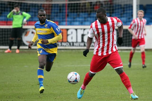 Brackley Town's Greg Kaziboni is closed down by Solihull Moors Junior English at St James Park