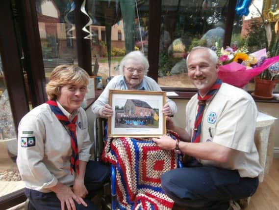 Elfrida Harper-Tarr is pictured receiving her framed picture from Alison Westcott, left, and David Edwards, right on her birthday on July 14. NNL-150721-153116001