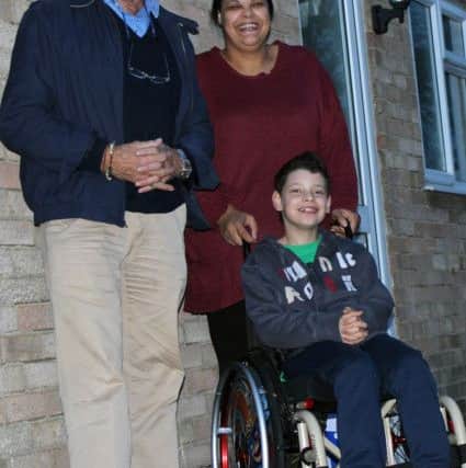 Malakai White, with mum Georgina, receives his wheelchair from Rockingham Kiwanis Alan Roadknight