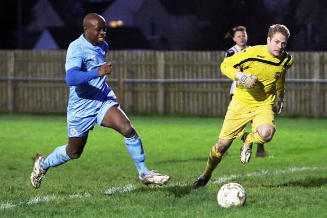 Ardley United's Ade Talabi and Lydney Town keeper Richard Thomas go for the ball