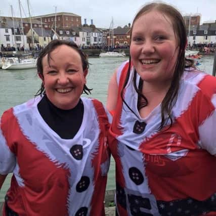 Maria Parish and her daughter Rosie after completing the Christmas Day swim along Weymouth Harbour. They were raising money for the Alzheimer's Society.
