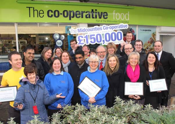 Local community groups with their grant cetificates and Midcounties Co-operative director Steve Allsopp (centre) at the Botley Co-op store