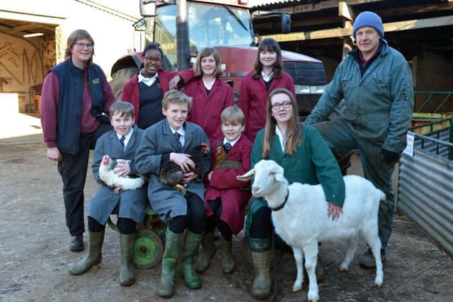 Isabel Hands, assistant farm manager, left and Chris Holloway, farm manager, right, with year 7, 8 and 9 pupils.