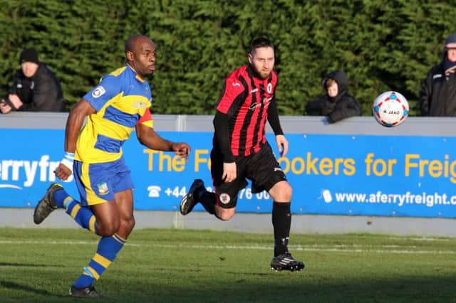 Brackley Town's Steve Diggin takes on Solihull Moors' Theo Streete at St James Park