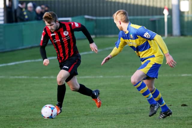 Brackley Town's  Liam Marsden takes on Solihull Moors' Connor Franklin at St James Park