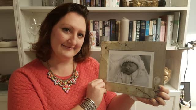 Lydia Berry with a picture of baby Evelyn
