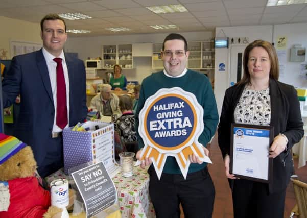 Halifax Community Ambassador Helen Hicks and Halifax Local Director, Alex Thomas present Andy Willis with his award. Picture: onEdition