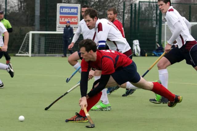 Banbury's Harry Loxton gets in a  shot despite the attentions of Milton Keynes Nick Anderson