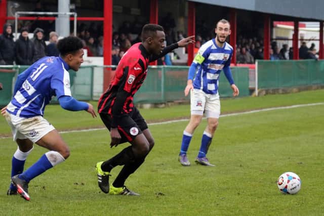 Brackley Town's David Moyo and Nuneaton Town's Wesley McDonald compete for the ball  at St James Park