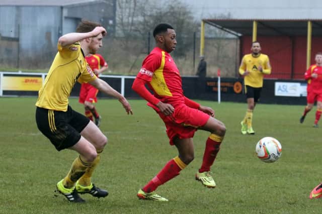 Banbury United's Leam Howards holds off North Leigh's Lewis White at Spencer Stadium
