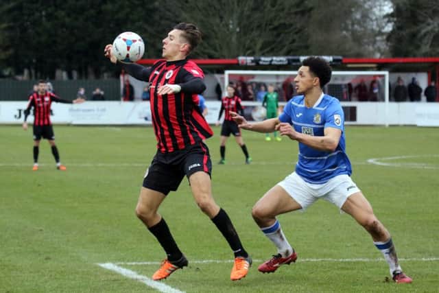 Brackley Town's Matt Lowe and Stockport County's Lewis Montrose compete for the ball at St James Park