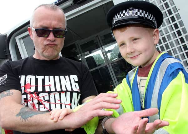 Last year's Banbury and District show held at Spiceball Park. Pictured, Joseph Selby (9) arresting Wayne Meade for being grumpy in public NNL-150615-093300009