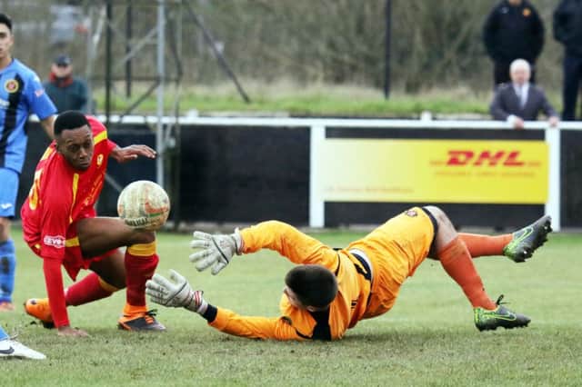 Banbury United's Leam Howards is thwarted by Winchester City keeper Brendan Norris at Spencer Stadium