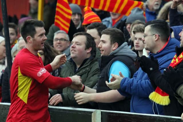 Banbury United's Ricky Johnson celebrates with the fans at the Town End at the end of Saturday's game