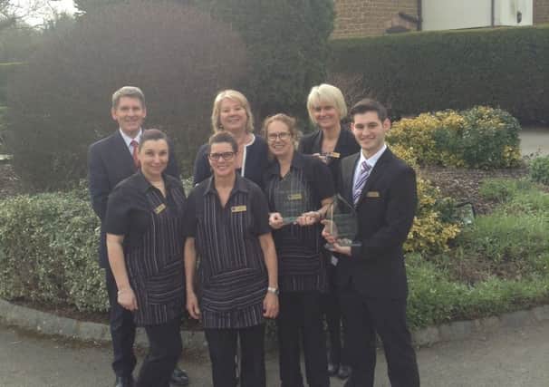 John and Gill Smith pictured with staff at the Wroxton House Hotel and their two awards. NNL-160229-115952001