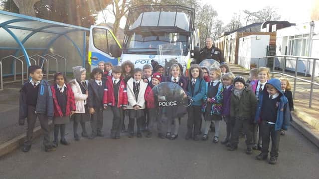 PCSO Rob Bliss pictured with pupils at the Grange County Primary School after he visited on Friday. NNL-160229-143049001
