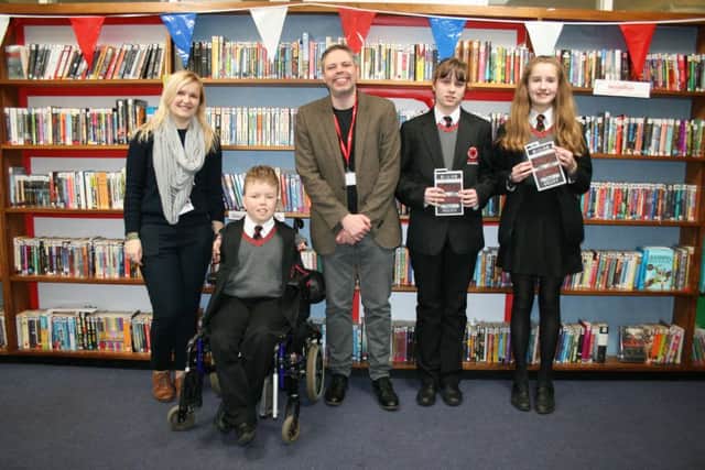 Author William Hussey pictured with Banbury Academy students in the library. NNL-160803-141834001