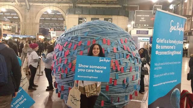 Emma Boiselle with the giant ball of wool at Victoria Station