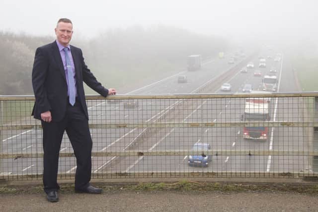 Councillor Mark Cherry pictured overlooking the M40 in the fog. NNL-160322-115855001