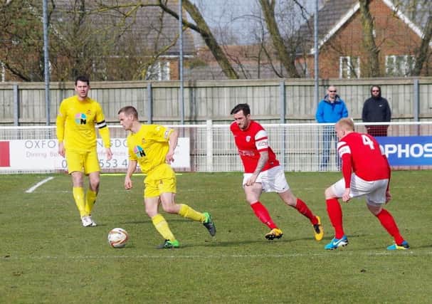 Banbury United's Olle Stanbridge comes away with the ball at Didcot Town. Photo: David Shadbolt