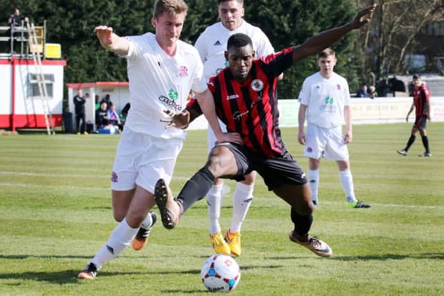 Brackley Town's Lee Ndlovu and AFC Fylde's Josh Langley challenge for the ball  at St James Park