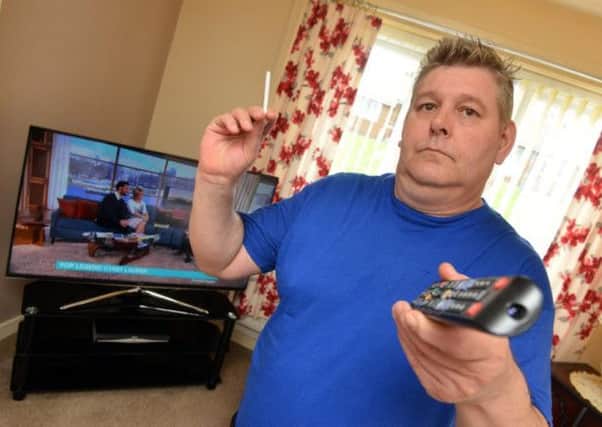 Thomas Defty with his new television after his old set was damaged by smoke according to Panasonic.