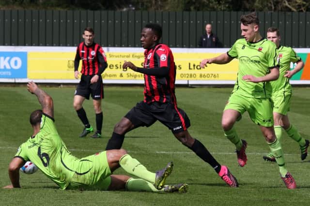 Brackley Town's David Moyo is denied by Chorley's Courtney Meppen-Walter and Jack Lynch  at St James Park