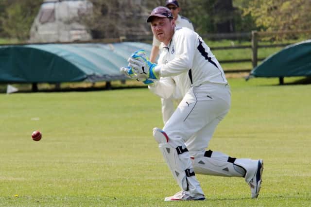Sandford St Martin wicket keeper Nick Leader deals with a delivery at Cropredy