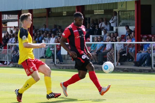 Brackley Town's Lee Ndlovu takes on Tamworth's Andy Burns at St James Park