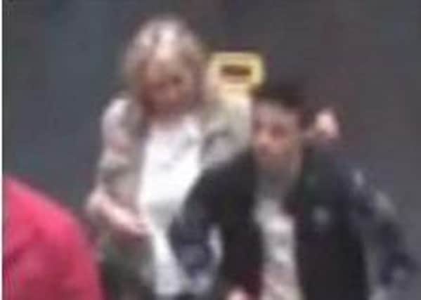 CCTV footage of a man and a woman police would like to talk to in connection with a theft at Bicester Village. PNL-160817-124157001