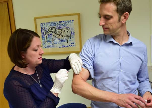 Dr Joe McManners having his flu jab at the Manor Surgery in Oxford NNL-161013-115048001
