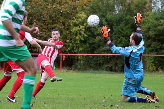 Josh Northam fires past Thame United keeper Henry Craven to give Easington Sports the lead