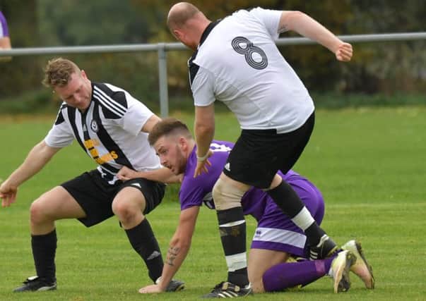 Daventry Town's James Tricks gets squeezed out at Moulton