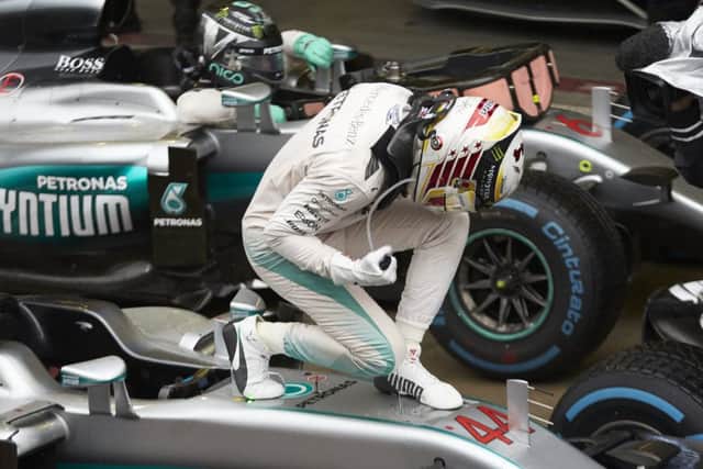 Lewis Hamilton climbs out of his car following his victory in Sundays Brazilian Grand Prix