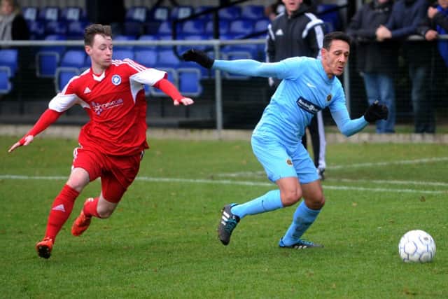 Ardley United's Troy Bryan escapes the challenge of Brimscombe & Thrupp's Ben Deakin