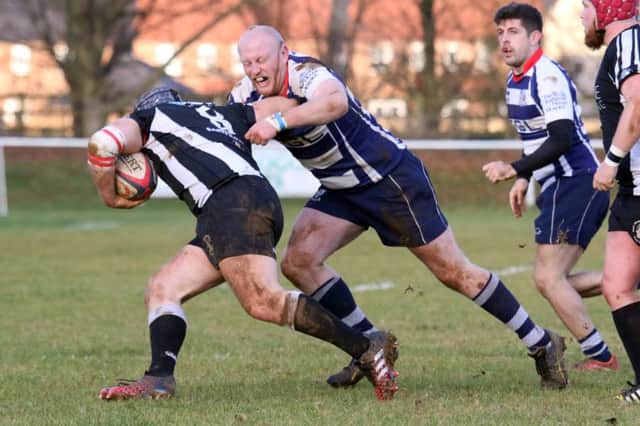 Banbury Bulls' Chris Phillips gets to grips with Royal Wootton Bassett at Bodicote Park