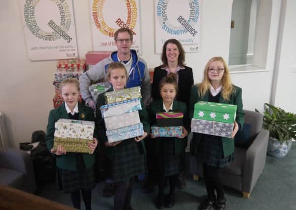 Pupils Polly, Isobel, Evie and Jessica with Rich Parsons and school charity co-ordinator Zoe Simms