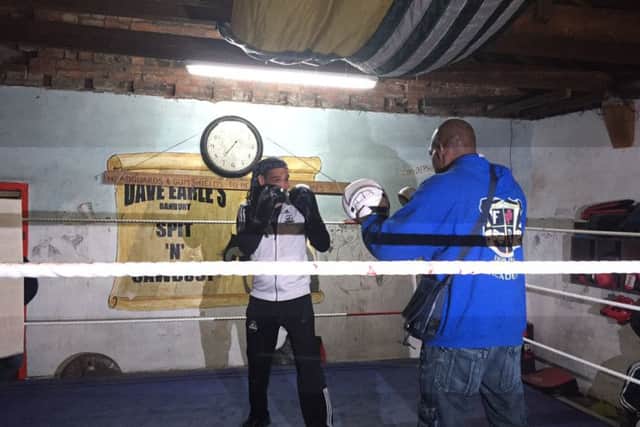 Dave Earle and former heavyweight champion boxer Frank Bruno in the ring using the pads at Spit 'n' Sawdust gym. NNL-160325-121748001