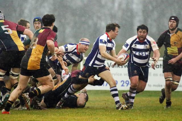 Ed Phillips looks to get the ball away for Banbury Bulls against Windsor at Bodicote Park