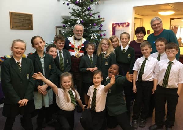 Banbury mayor Cllr Gordon Ross joins in the celebrations at The Ridings care home with children from Dashwood Banbury Academy who entertained the residents