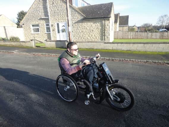 Richard Brown as he test drives the Batec electric attached to his wheelchair NNL-161228-165525001