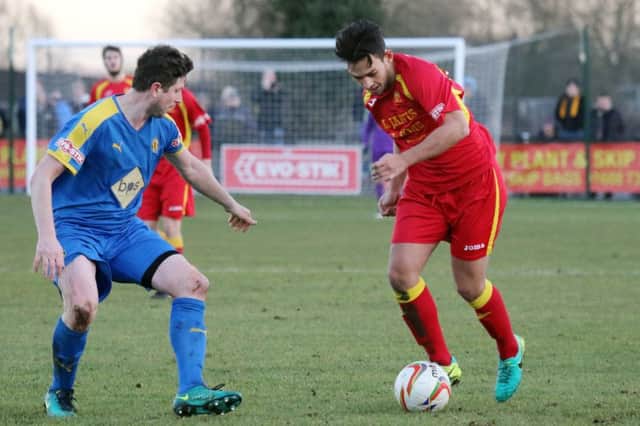 Banbury United's influential midfielder Zac McEachran takes on Leamington's Callum Gittings